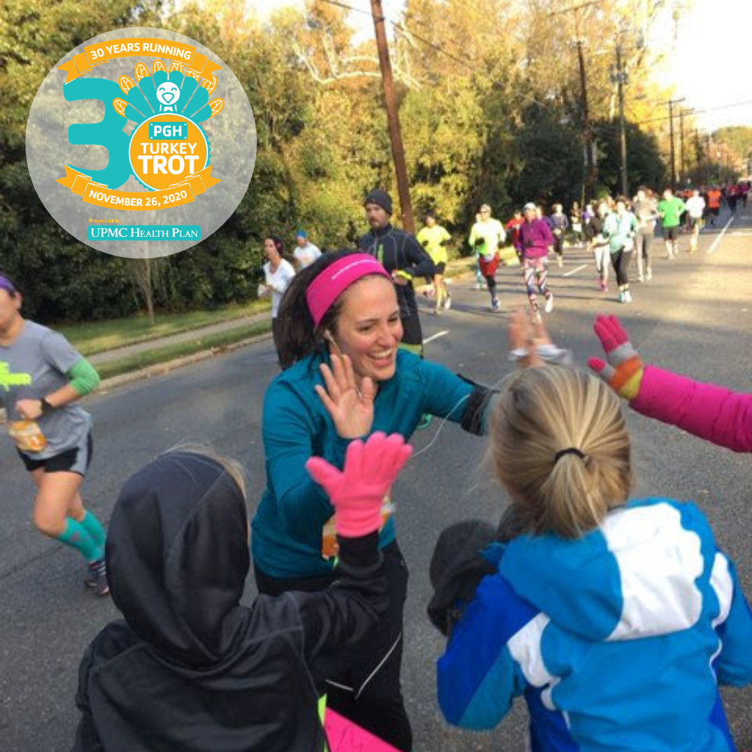 P3Runner Katie Kinnamon high-fives her family on the race course