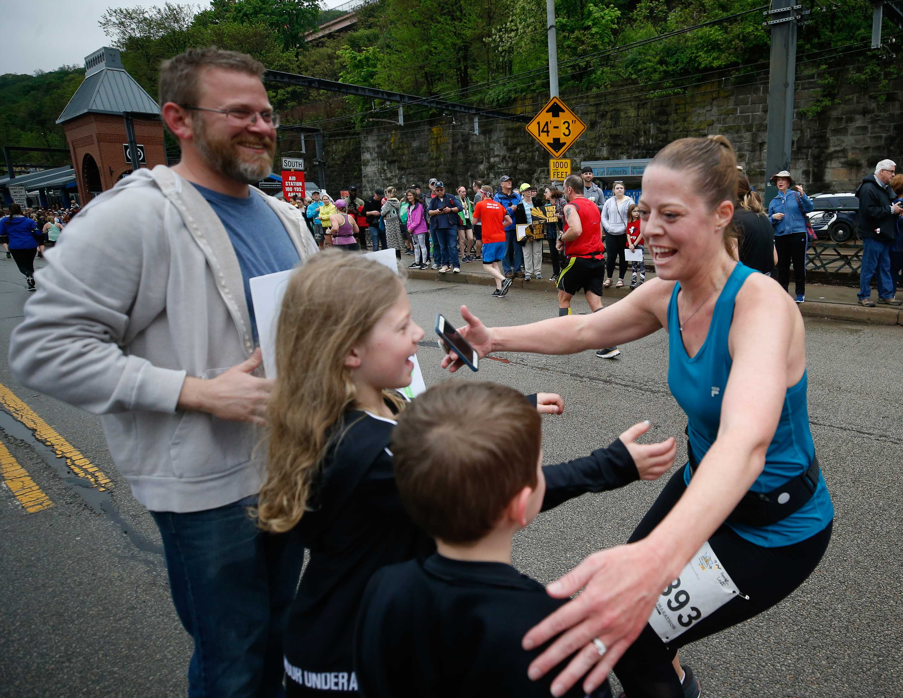 Female Run For A Reason Charity Program runner hugging her kids after the DICK'S Sporting Goods Pittsburgh Marathon