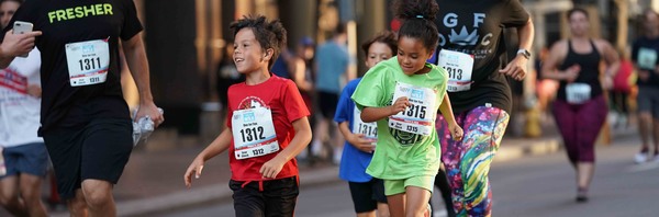 Two kids running in the Fleet Feet Liberty Mile