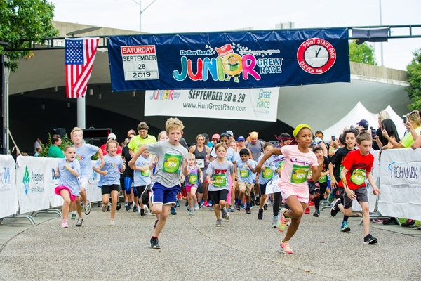 A large group of children running in the Dollar Bank Junior Great Race, which consists of the One-Mile Family Fun Run, Tot Trot, and Diaper Dash
