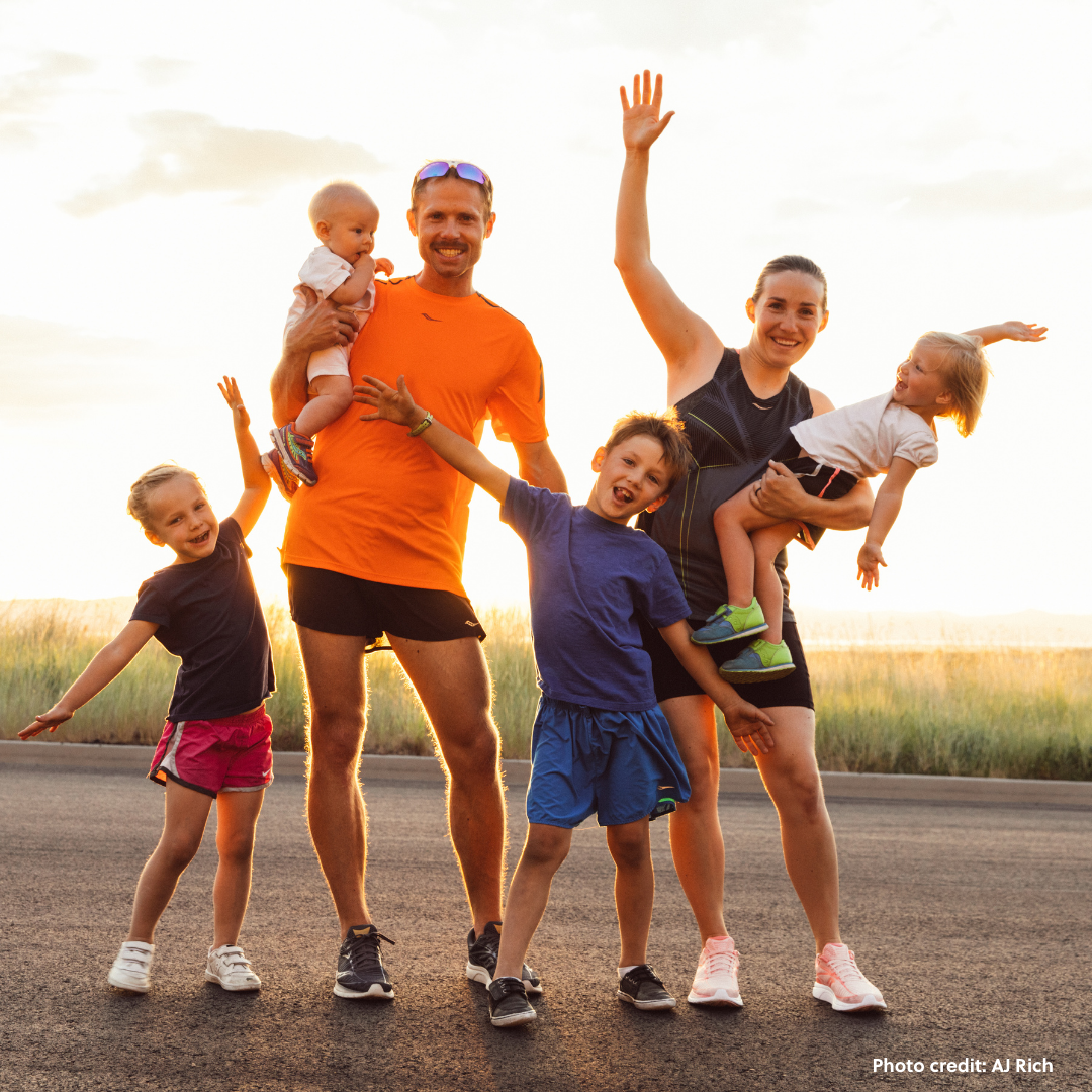 Olympian Jared Ward stands in front of a sunset with his wife and four young children.