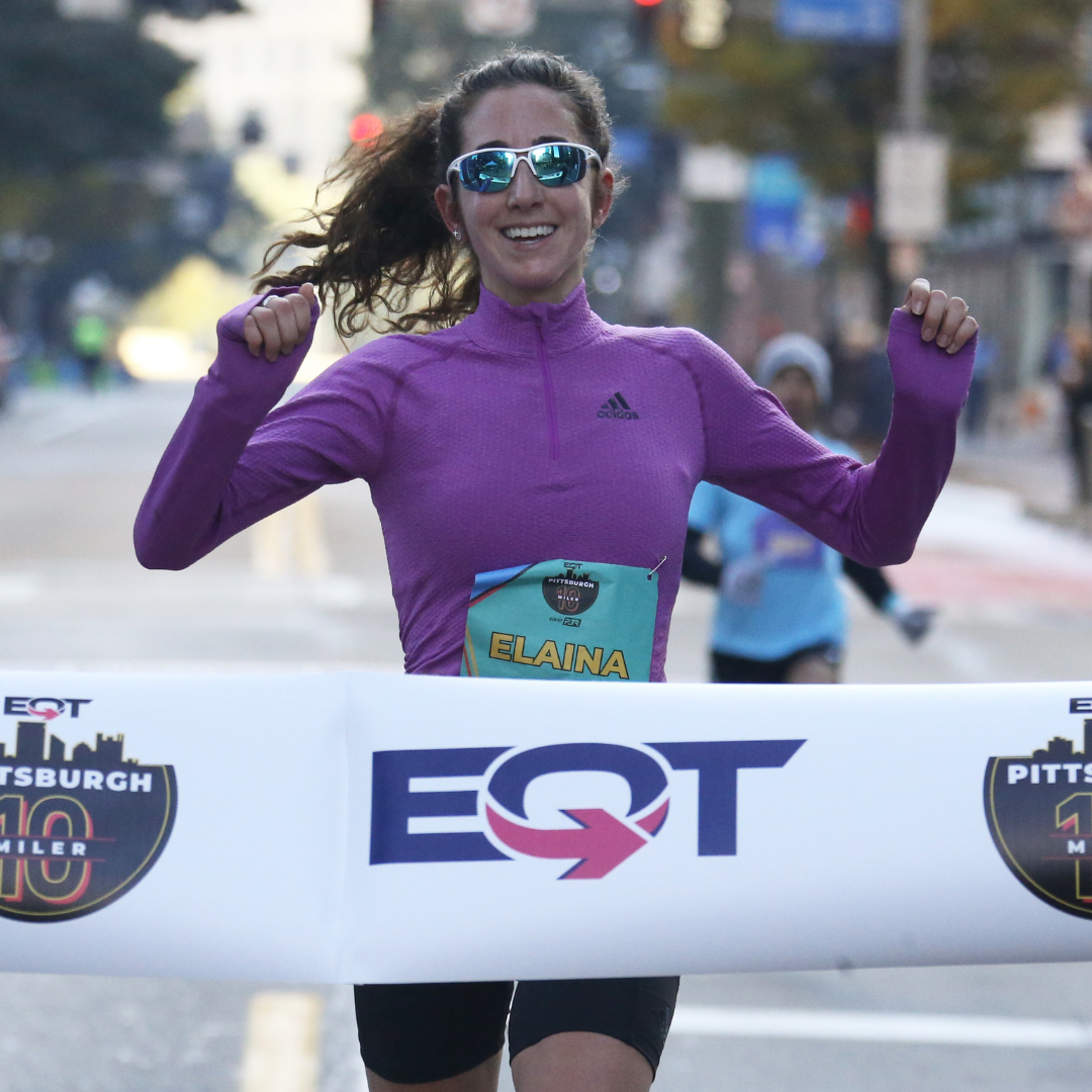 Elaina Tabb crossing the finish line