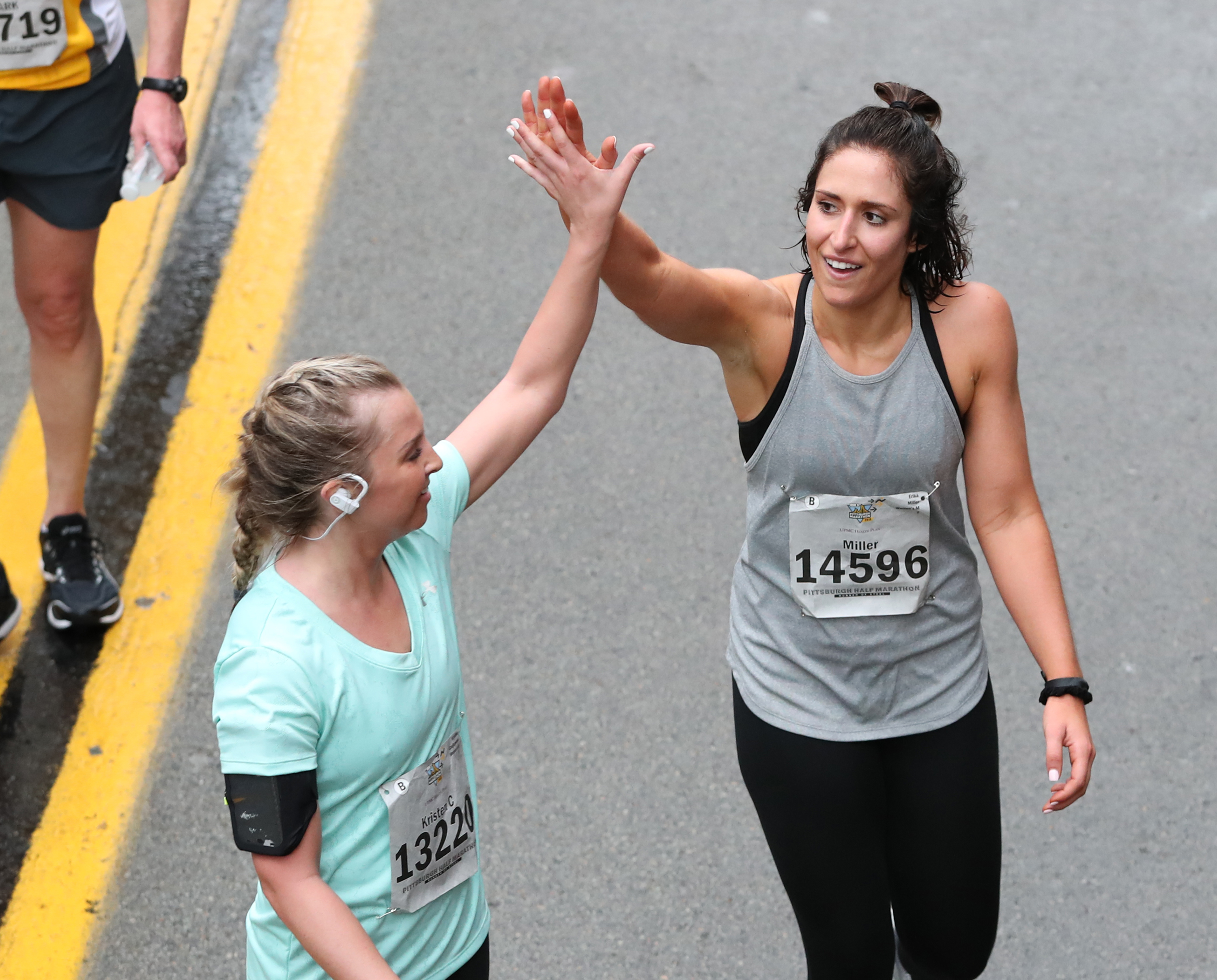 Two women celebrate at the finish line