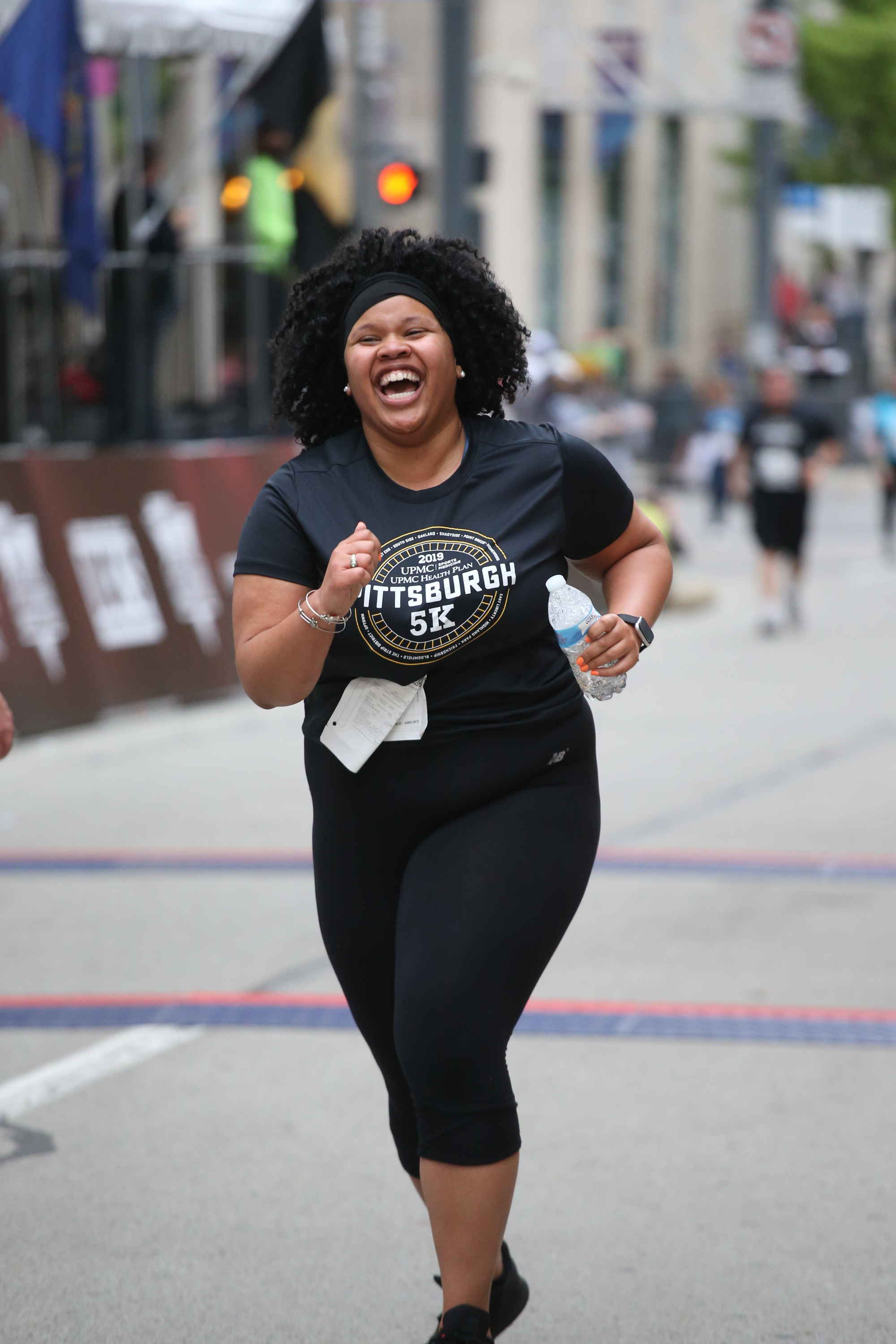 A woman races at the 2019 5K