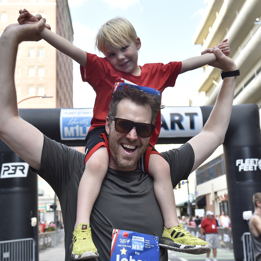 A man and his son at the 2022 Fleet Feet Liberty Mile.