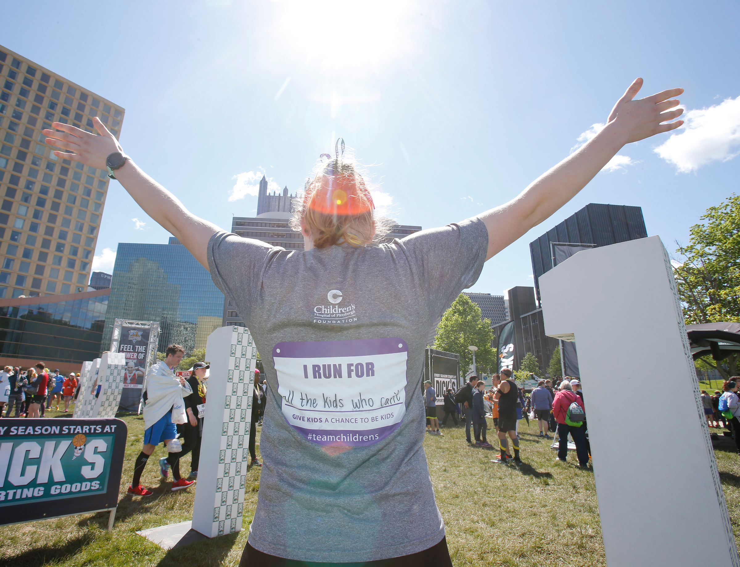 A charity runner celebrates their accomplishment