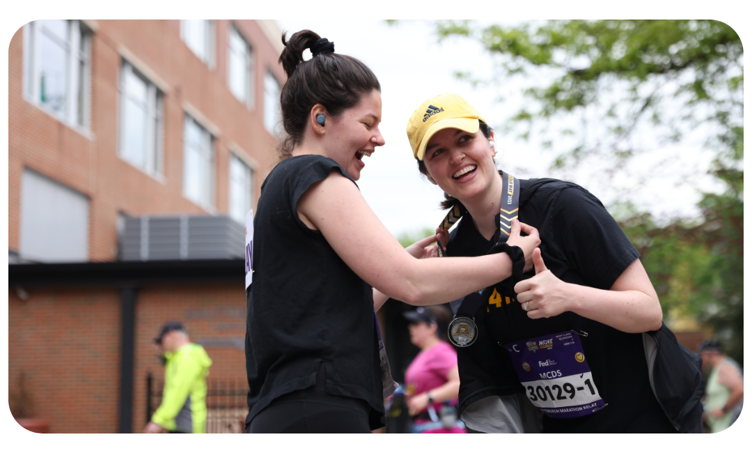 Two women at a relay exchange zone