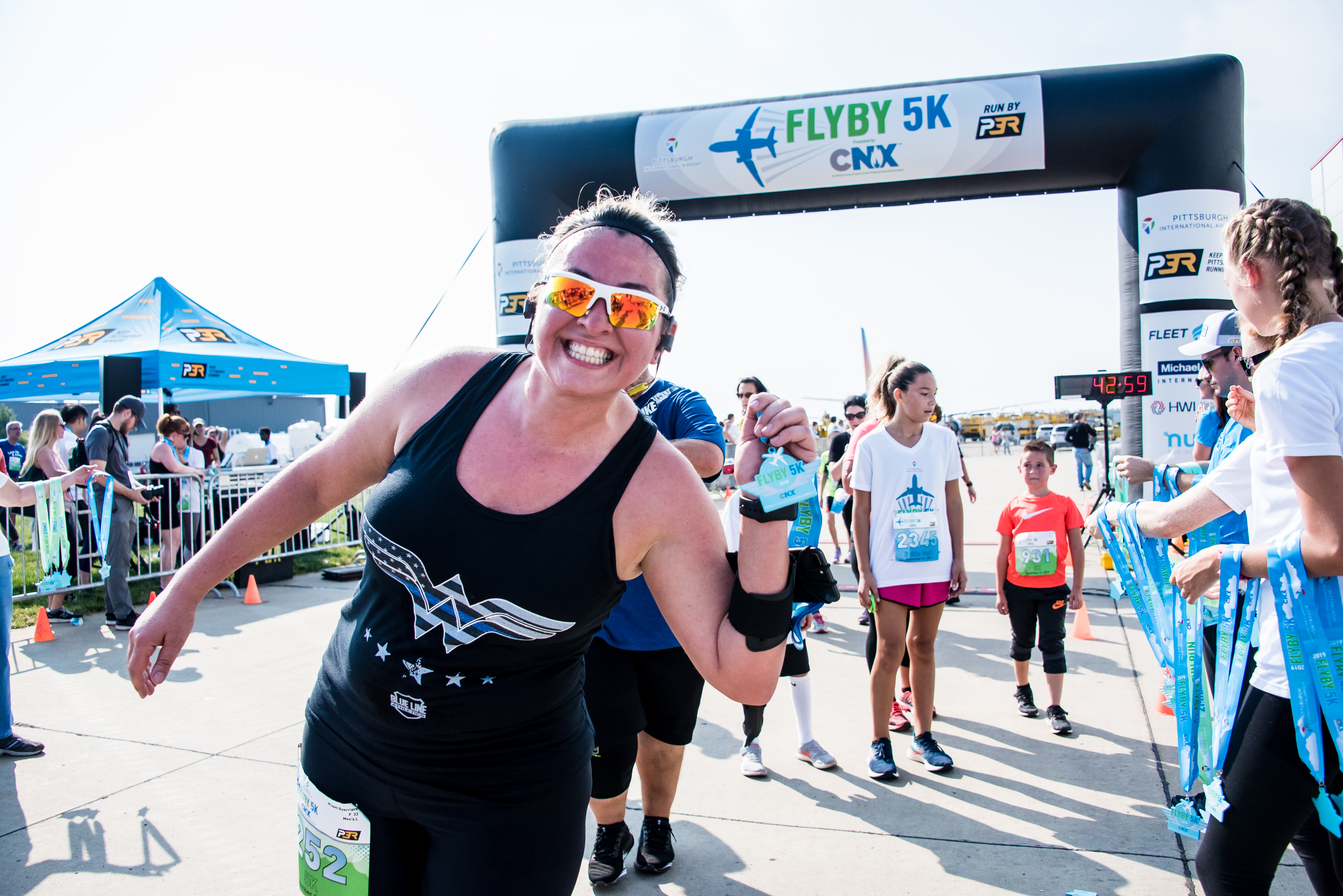 A woman at the FlyBy 5K finish line