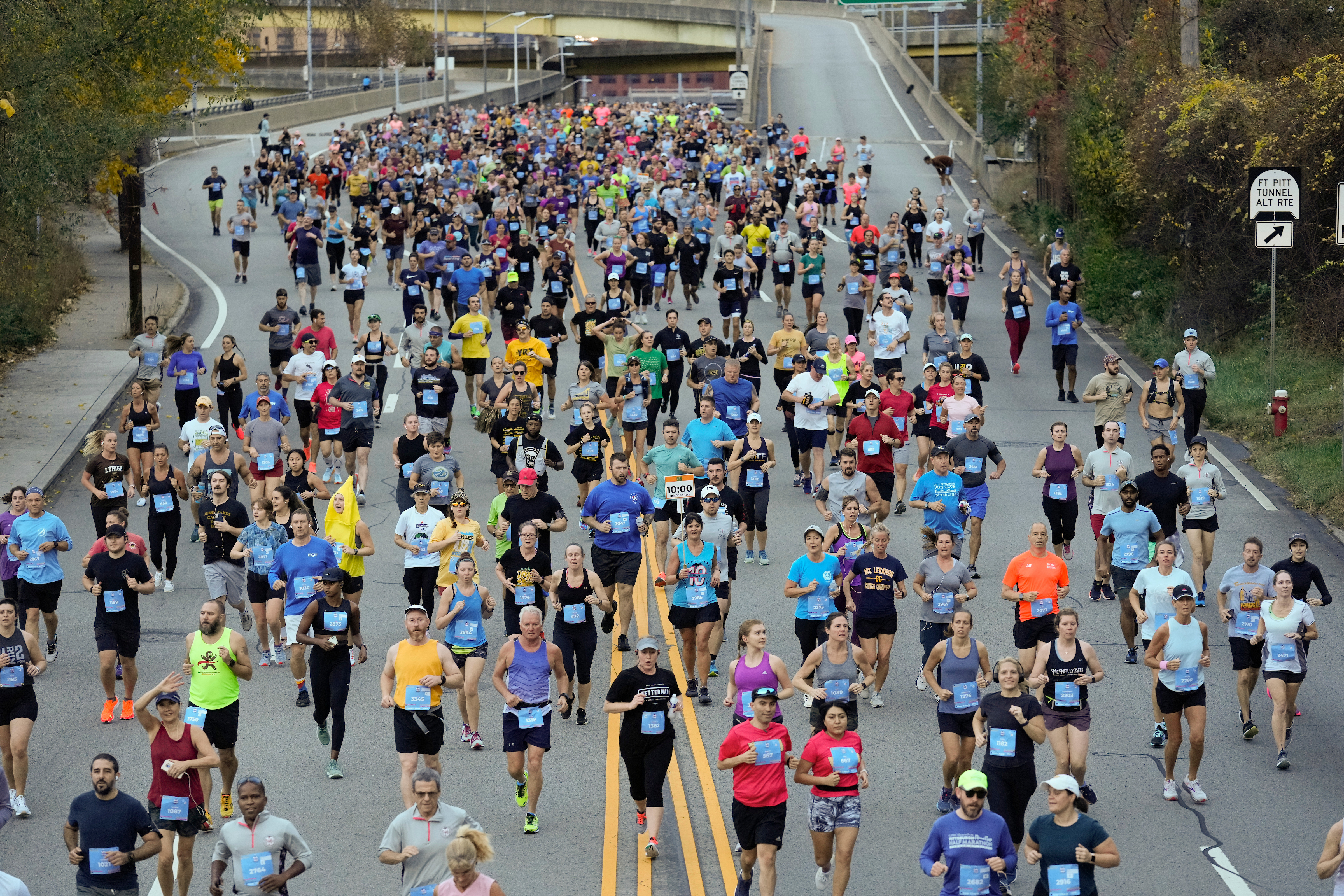 Large group of people running from the start line of the EQT Pittsburgh 10 Miler race