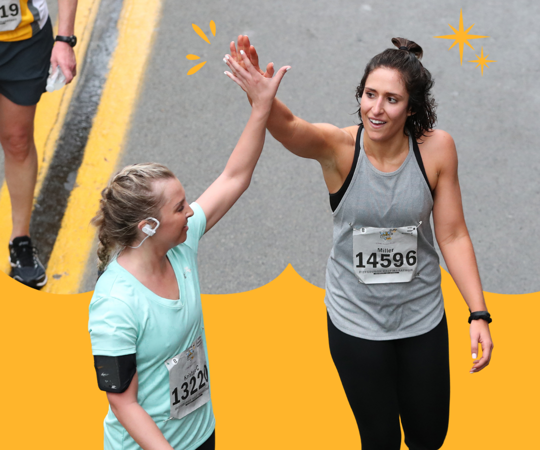 Two women celebrate at the finish line