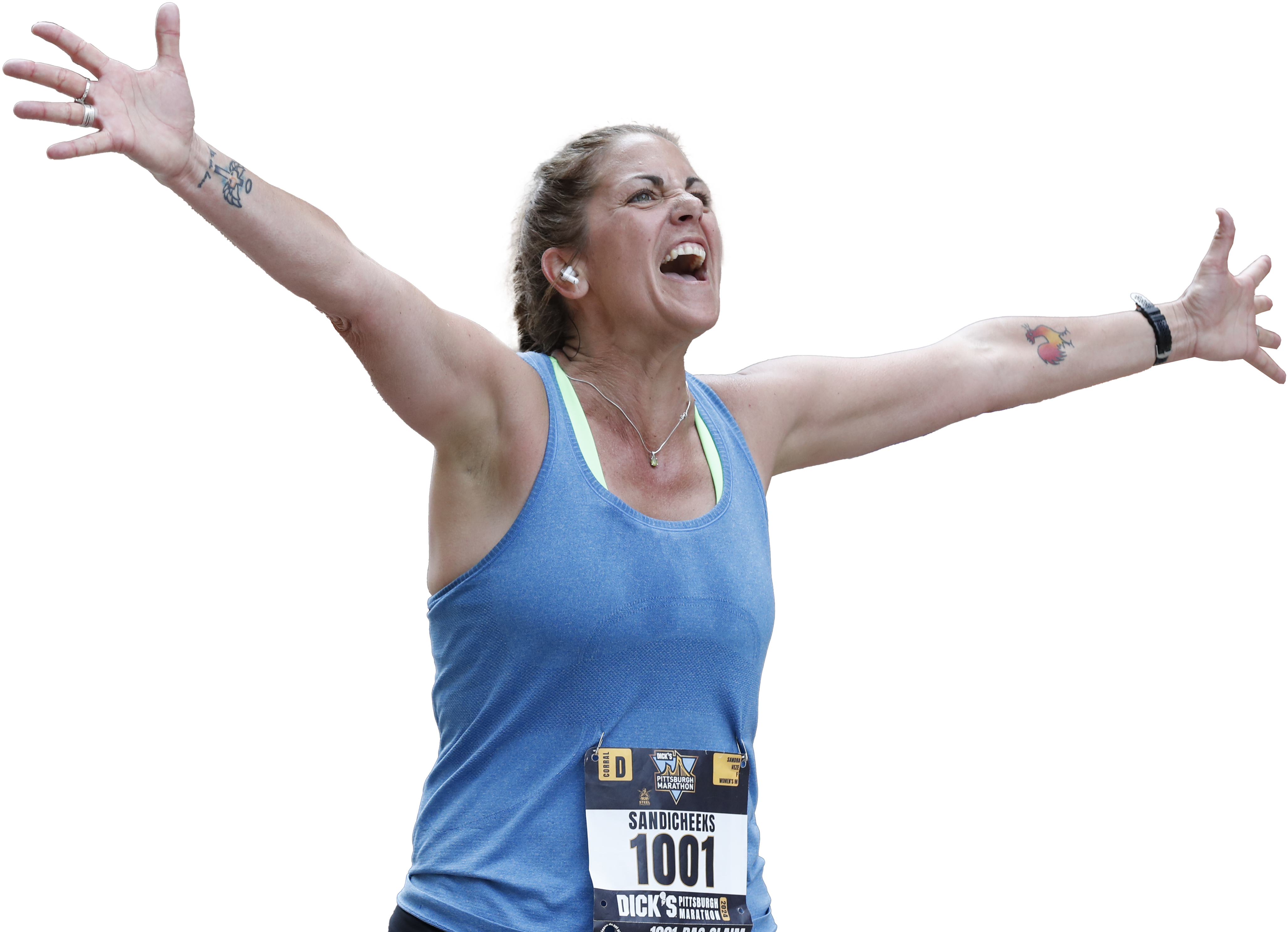 Woman in running clothes raising her hands with an excited expression.