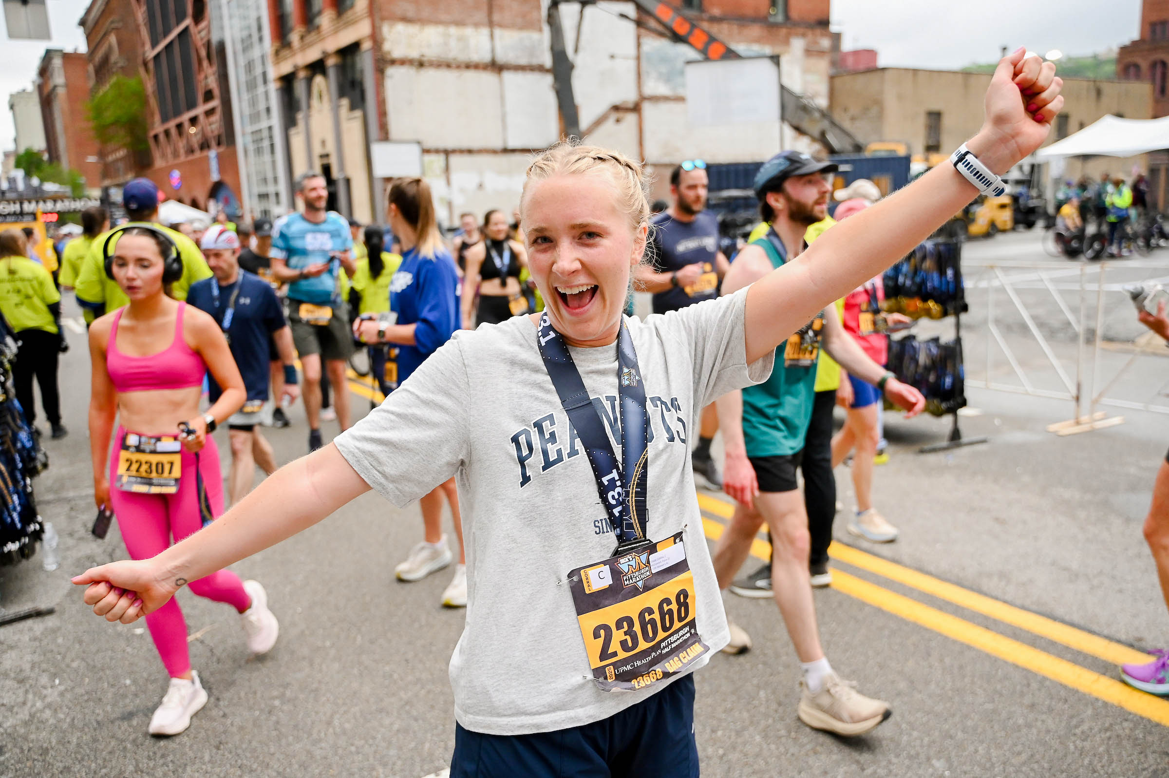 Woman celebrating with Half Marathon medal