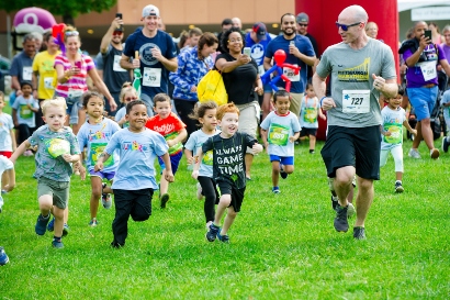 Children running in a grassy field.