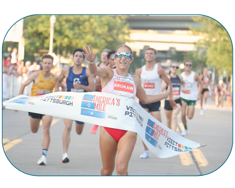 Elite Runner crossing finish line tape