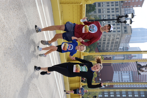 A large group of children running in the Dollar Bank Junior Great Race, which consists of the One-Mile Family Fun Run, Tot Trot, and Diaper Dash